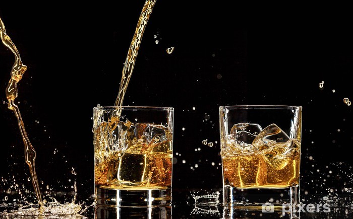 Alcohol drinks with splashes, isolated on black background